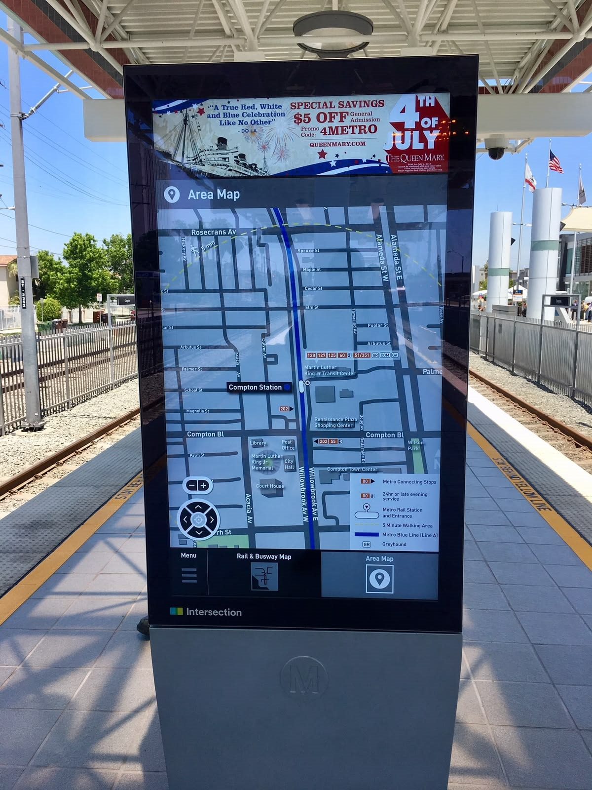 Transit-station wayfinding touchscreen kiosk showing an area map on a platform