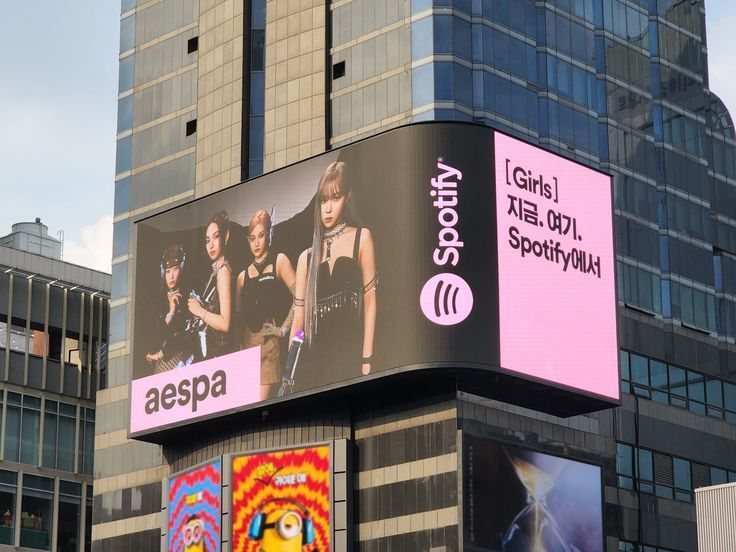 Curved outdoor LED advertising display on a commercial building facade