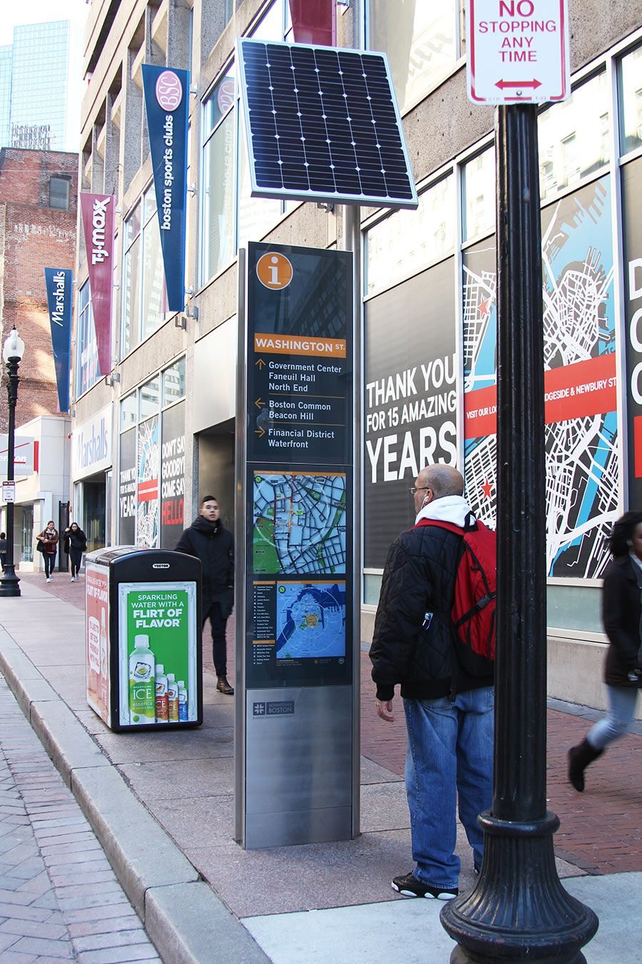 Solar-powered outdoor wayfinding kiosk on a city sidewalk