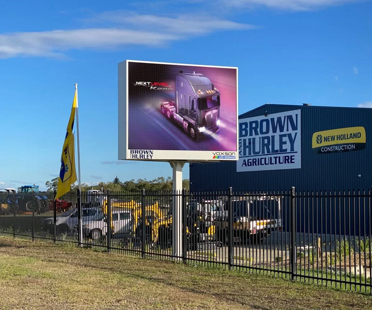 Pole-mounted outdoor LED billboard at an industrial site