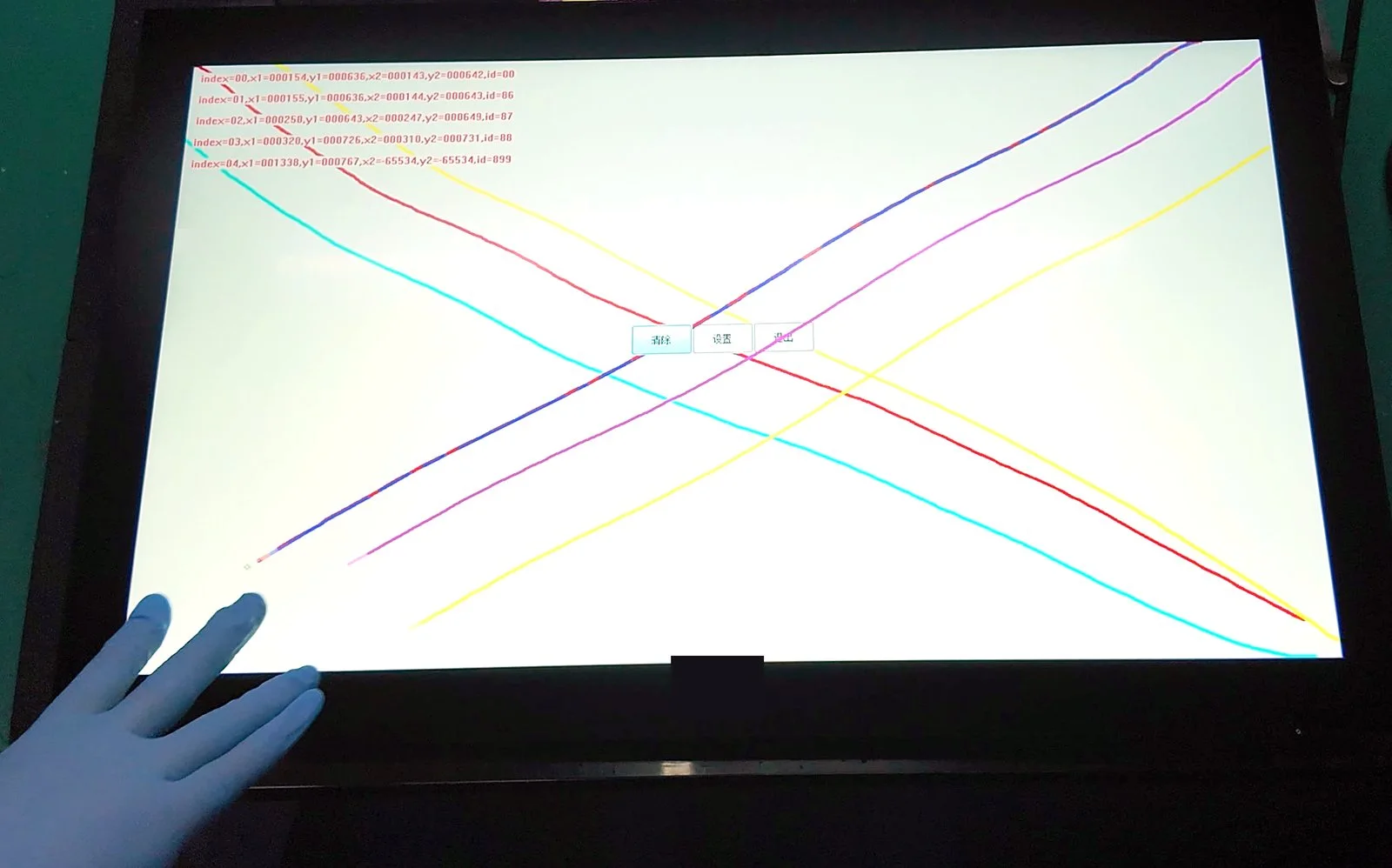 A PCAP touchscreen tracking multiple touch points with a gloved hand on a test bench, with live coordinate data on screen