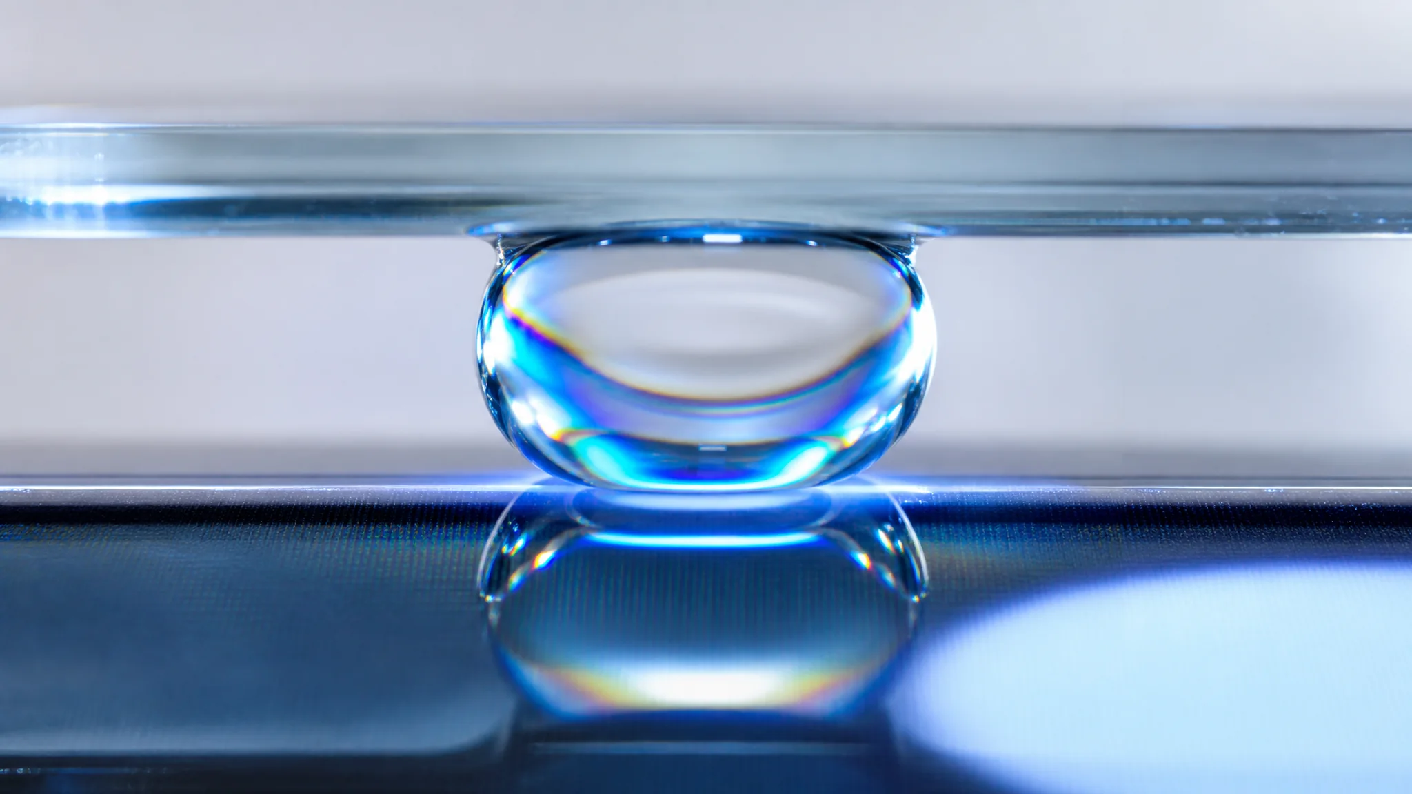 LOCA liquid optical clear adhesive — macro detail between bonded surfaces